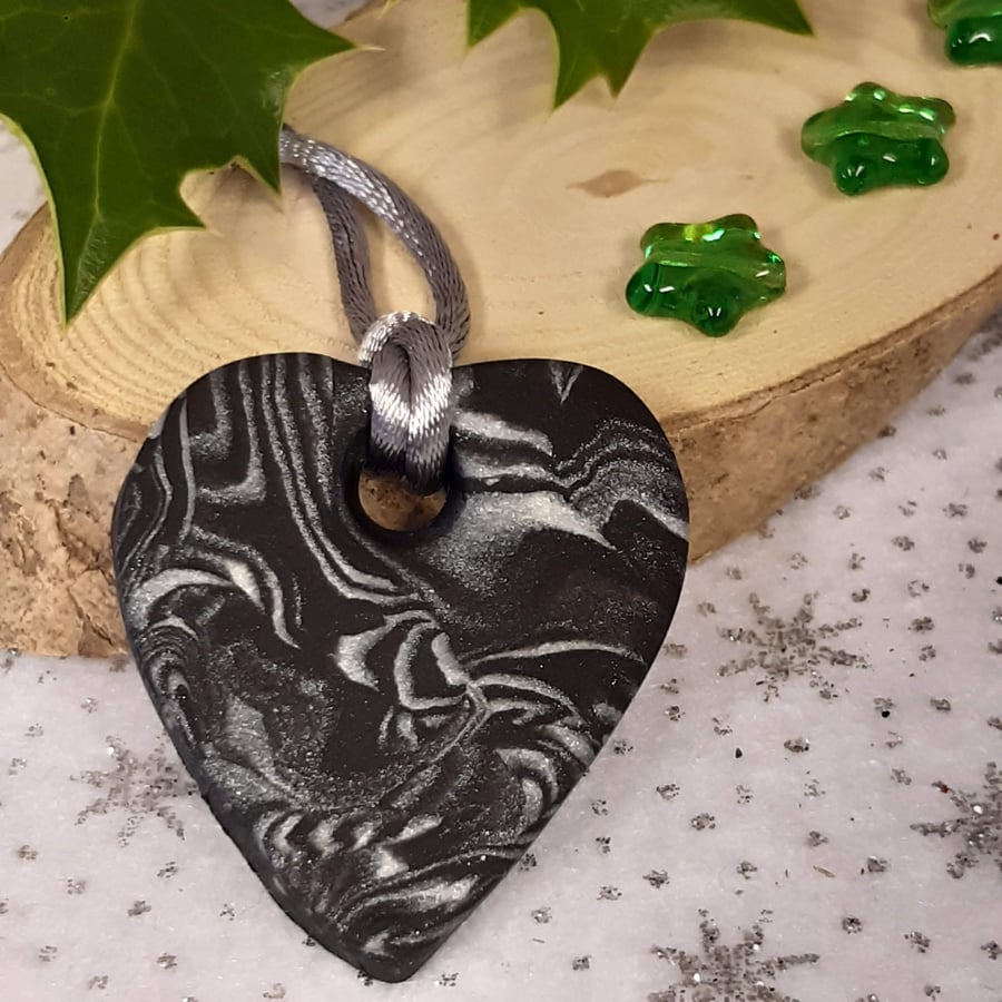 Black and silver heart shaped pendant