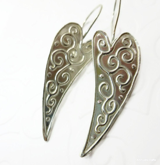 Silver heart dangle earrings.Curved hearts with raised pattern