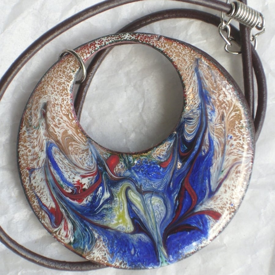 pendant - large, round, pierced scrolled bllue, red, yellow on white over clear