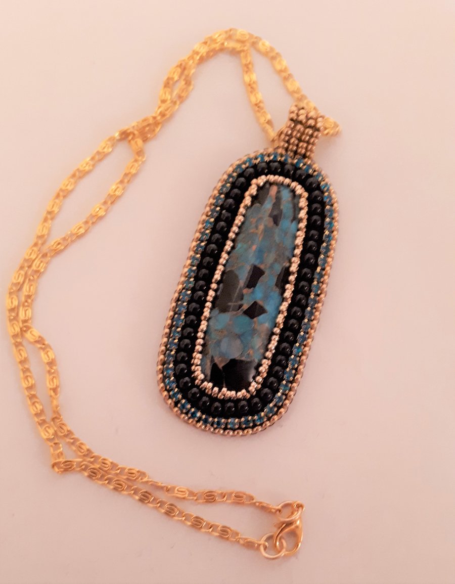 Bead embroidered Turquoise & Black cabochon pendant on a gold tone chain