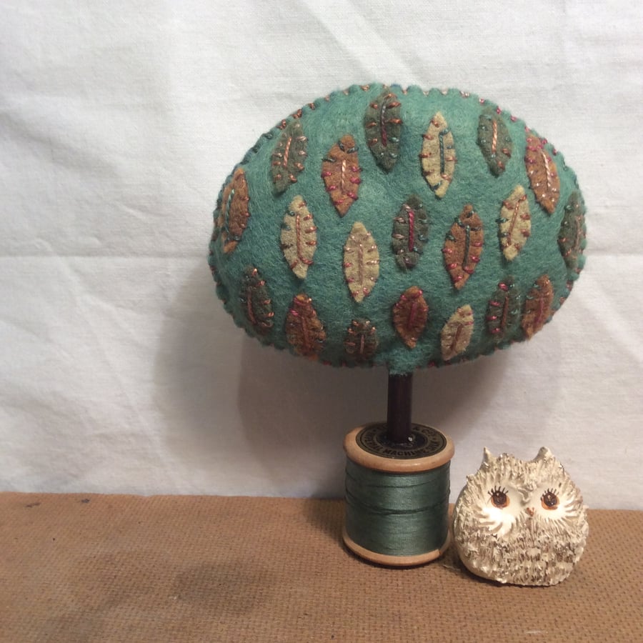 Cotton reel tree - green with multi coloured  leaves 