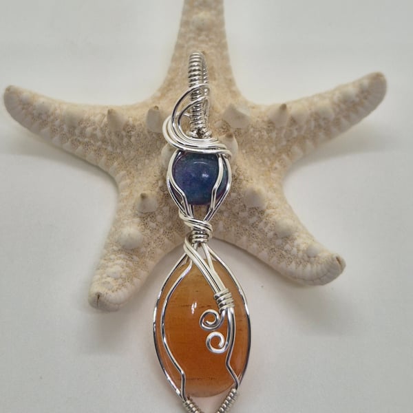 Peach Aventurine wire wrapped in silver with purple resin accent
