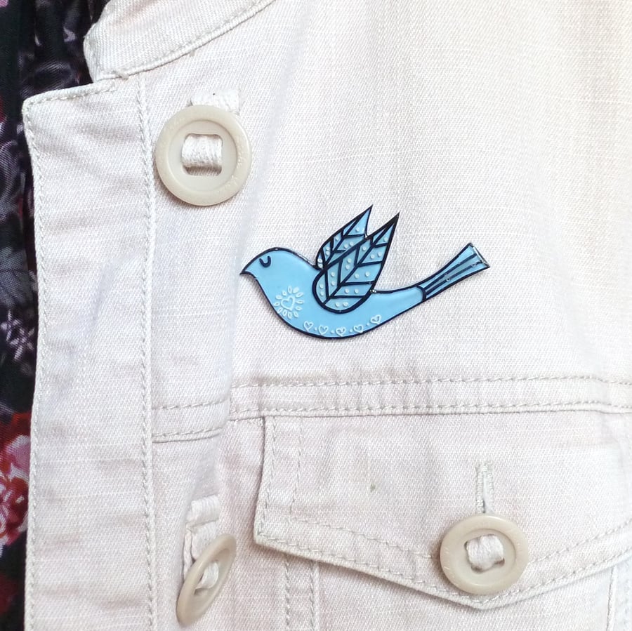 Pale blue folk art bird brooch. Blue hand-drawn jacket pin