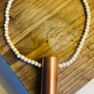 Beaded necklace with a copper pendant