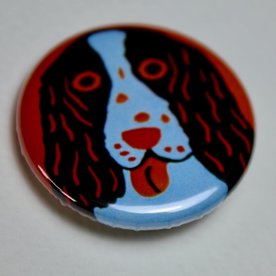 BLACK AND WHITE SPANIEL ON ORANGE BADGE