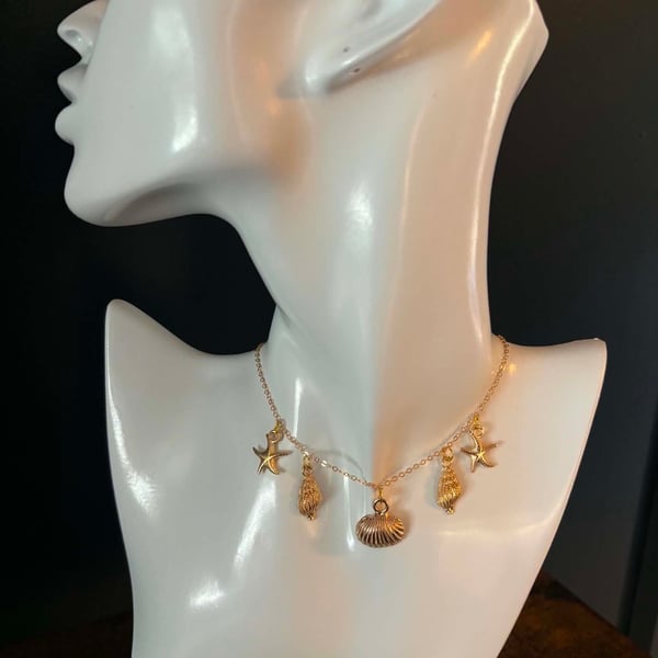 Gold Tone Shell & Starfish Charm Necklace