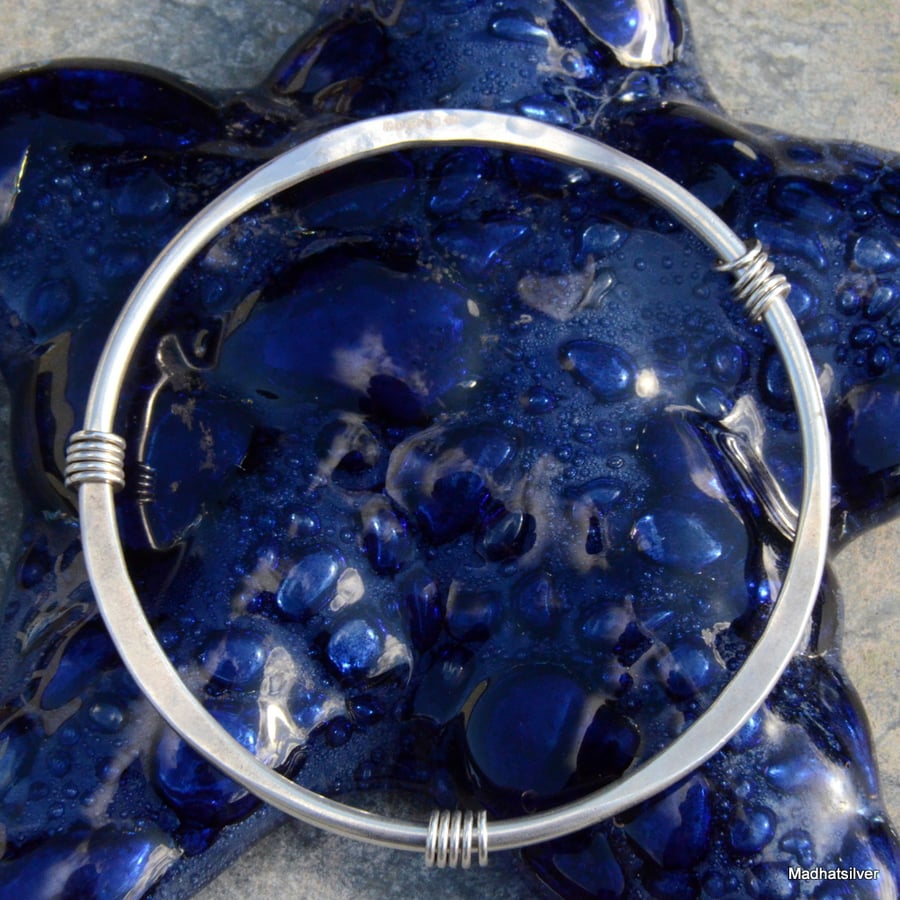 Silver bangle with sliding rings