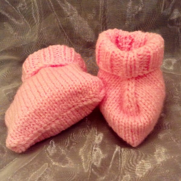 Pink knitted baby booties