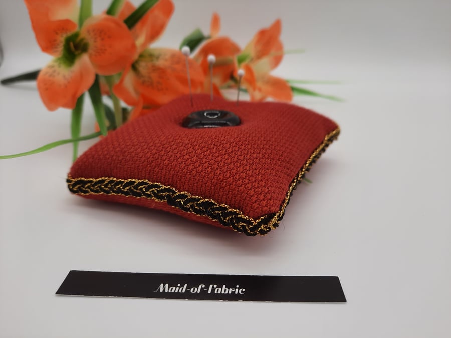 Pin cushion in red with black and gold trim