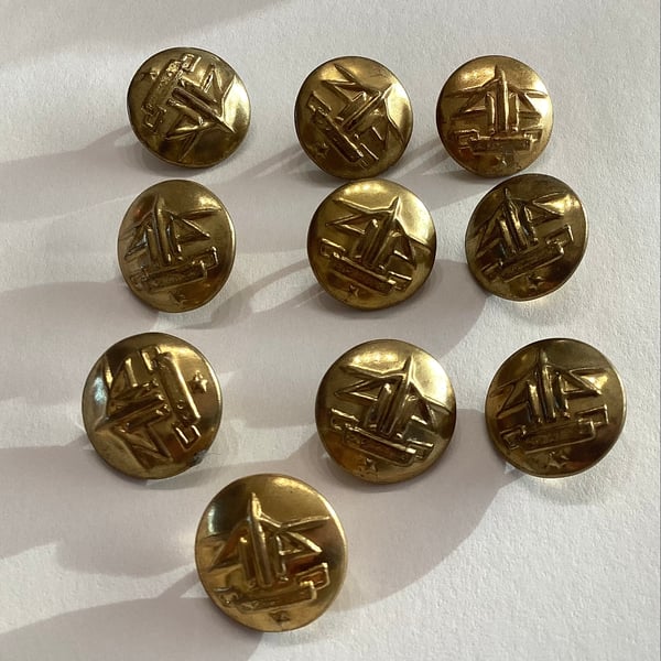 Brass coloured buttons, military style