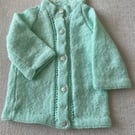 Longline baby cardigan with patterned front border