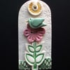 Ceramic tag decoration with bird and flower button