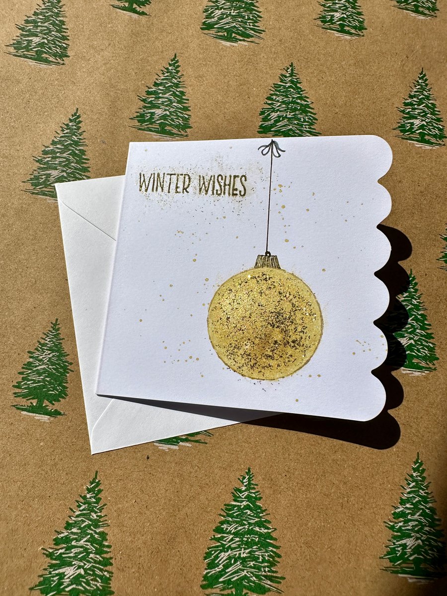 Unique modern Christmas card with gold bauble design and sparkle. 