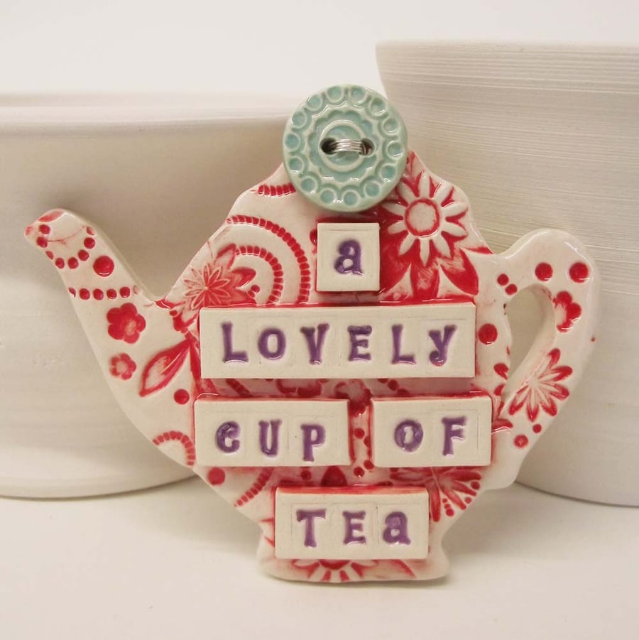 Ceramic teapot decoration with button detail