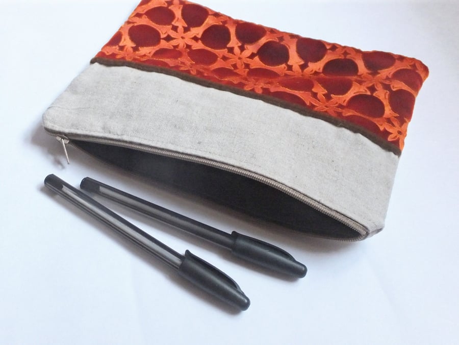 Orange large pouch bag with embossed velvet and linen design and zip top.