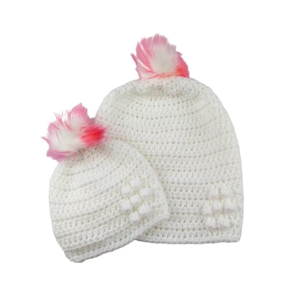 Matching ladies and baby white crocheted hats with detachable faux fur pompoms 