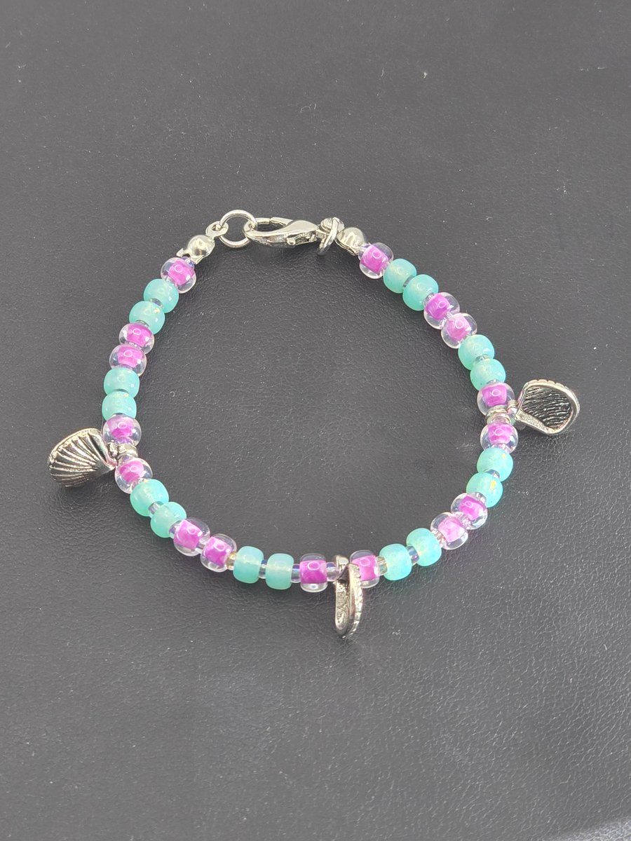 Kids glass beaded shell charm bracelet with sea green and plum beads 
