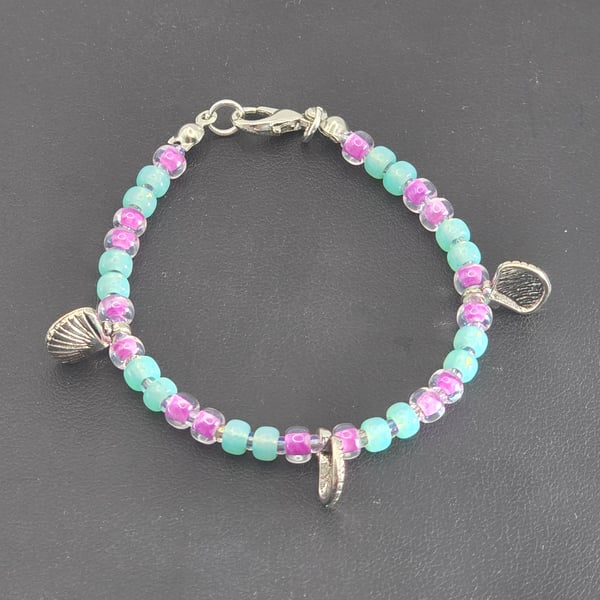 Kids glass beaded shell charm bracelet with sea green and plum beads 