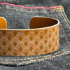 Scallop pattern aluminium cuff dark mustard