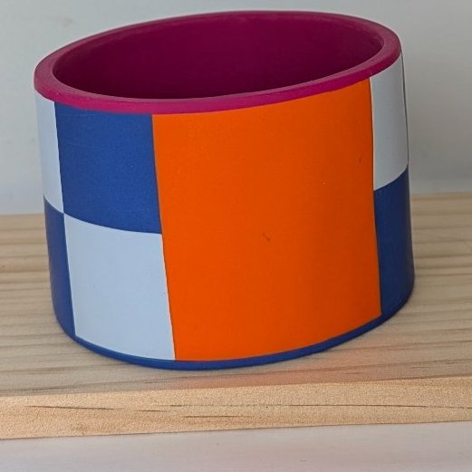 Dynamic blue colour block bangle with contrast orange and fuchsia 