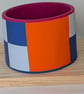 Dynamic blue colour block bangle with contrast orange and fuchsia 