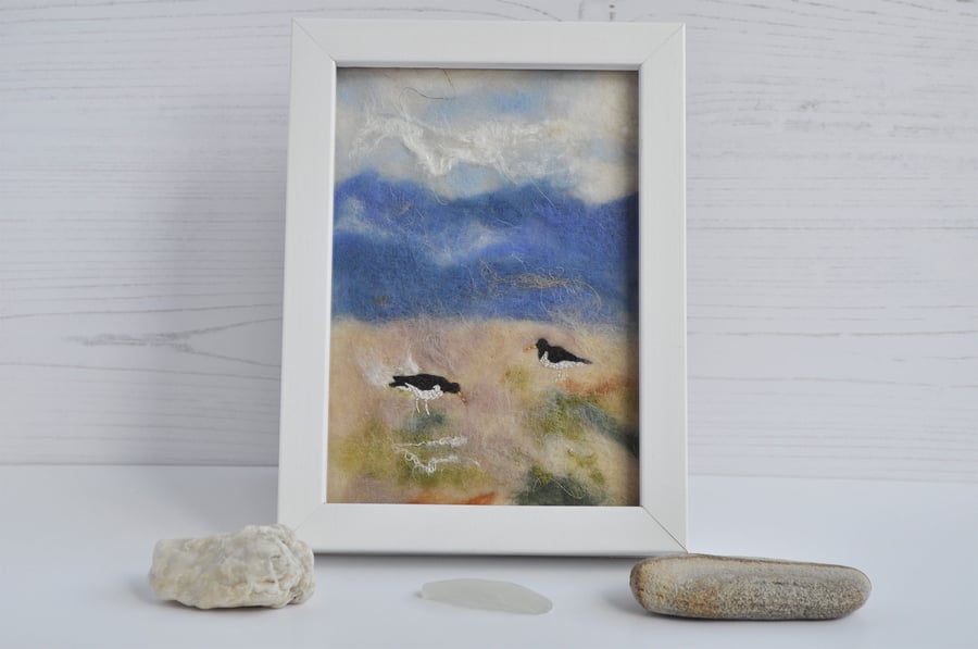 Framed oystercatchers embroidered on a needle-felted background 