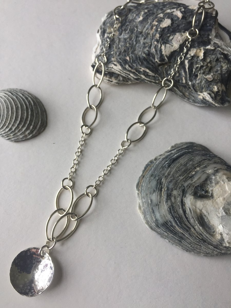 Sterling Silver Trace and Navette Link Chain with textured domed pendant .