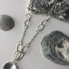 Sterling Silver Trace and Navette Link Chain with textured domed pendant .