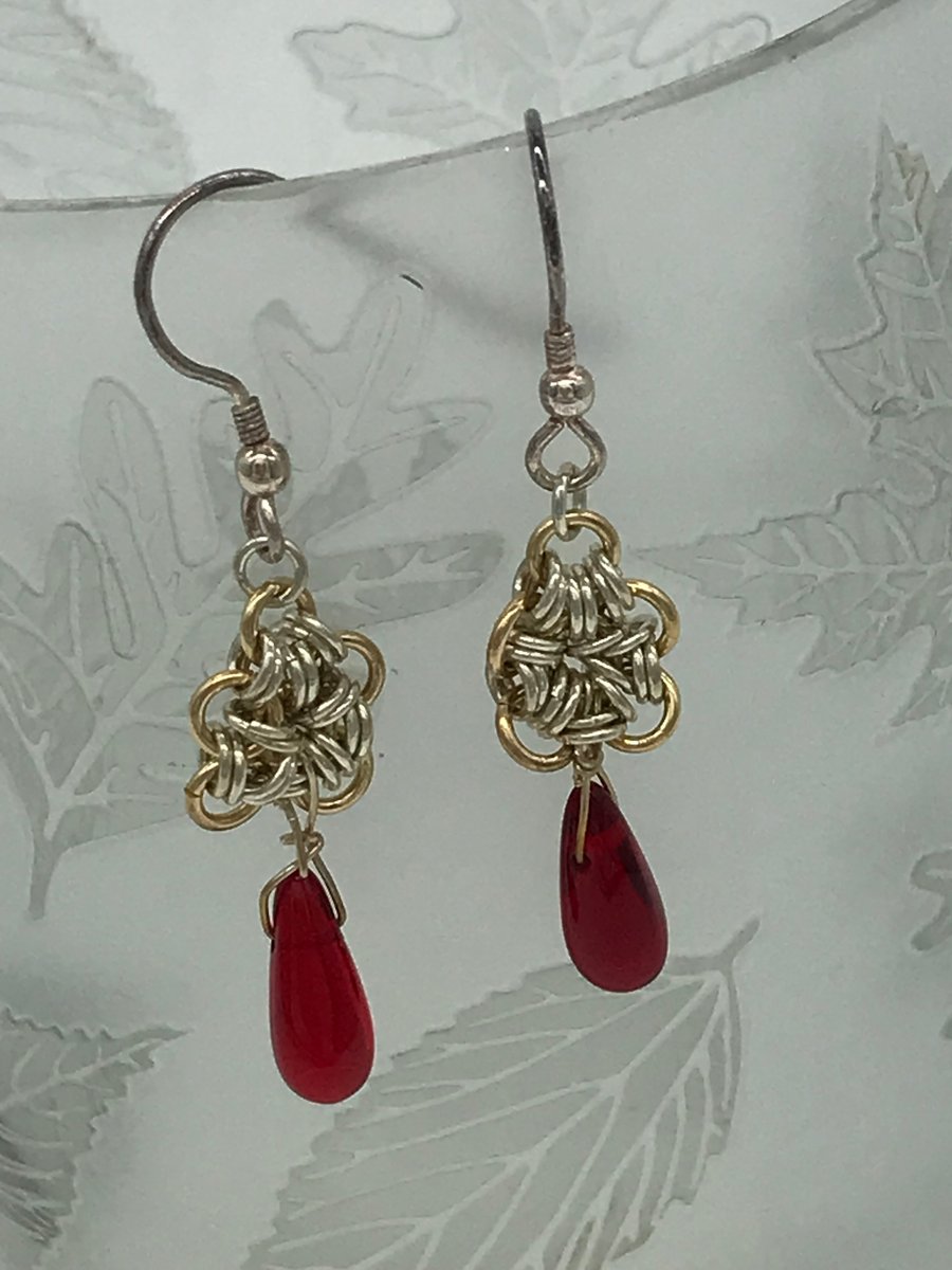 Silver and Gold coloured link flower with red beaded teardrop.