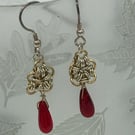 Silver and Gold coloured link flower with red beaded teardrop.