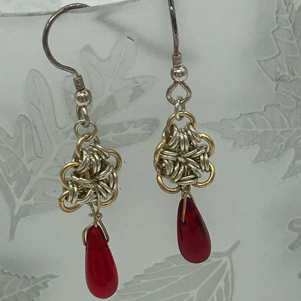 Silver and Gold coloured link flower with red beaded teardrop.