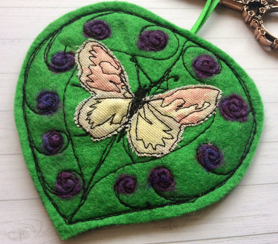 Handmade leaf and butterfly felting wool and machine embroidered decoration.
