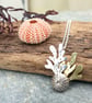 Silver sea urchin and seaweed pendant