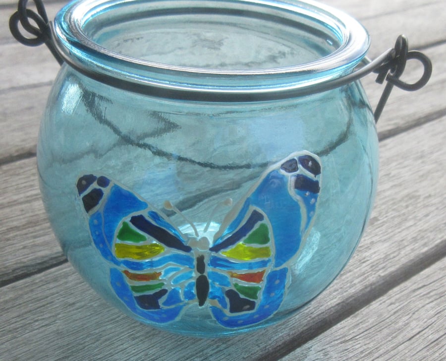 Cauldron shaped blue tea light holder with hand painted butterfly