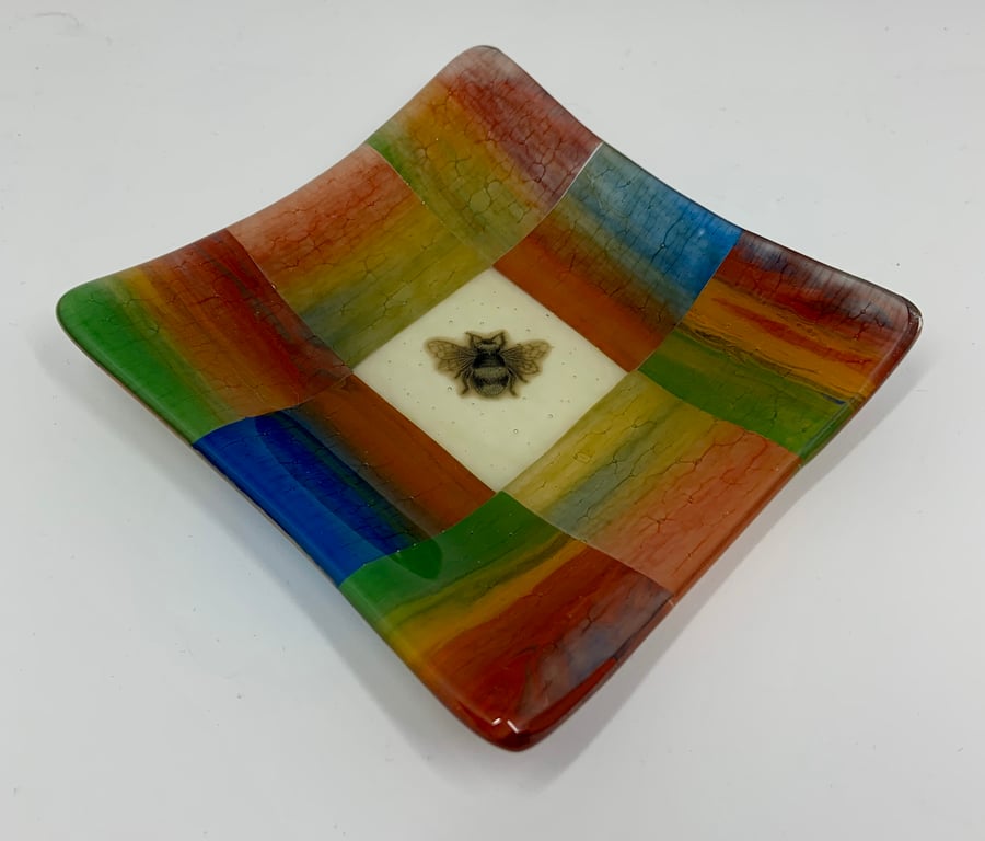 A Beautiful Fused Glass Blue, Green and Red toned glass bowl with bee design.