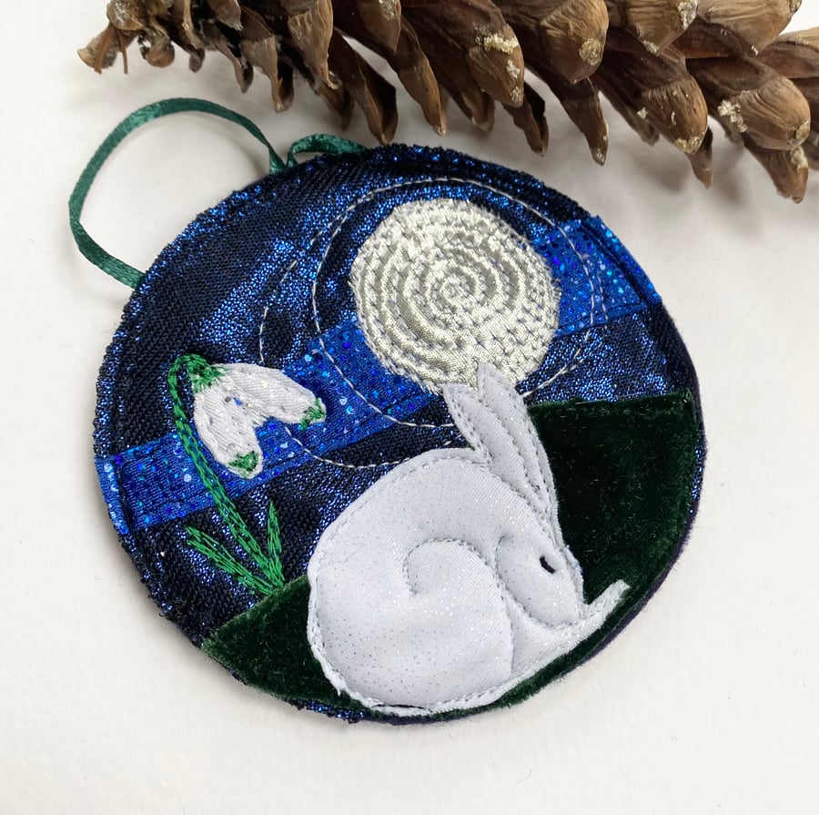 Upcycled embroidered sleeping hare and snowdrops home decoration. 
