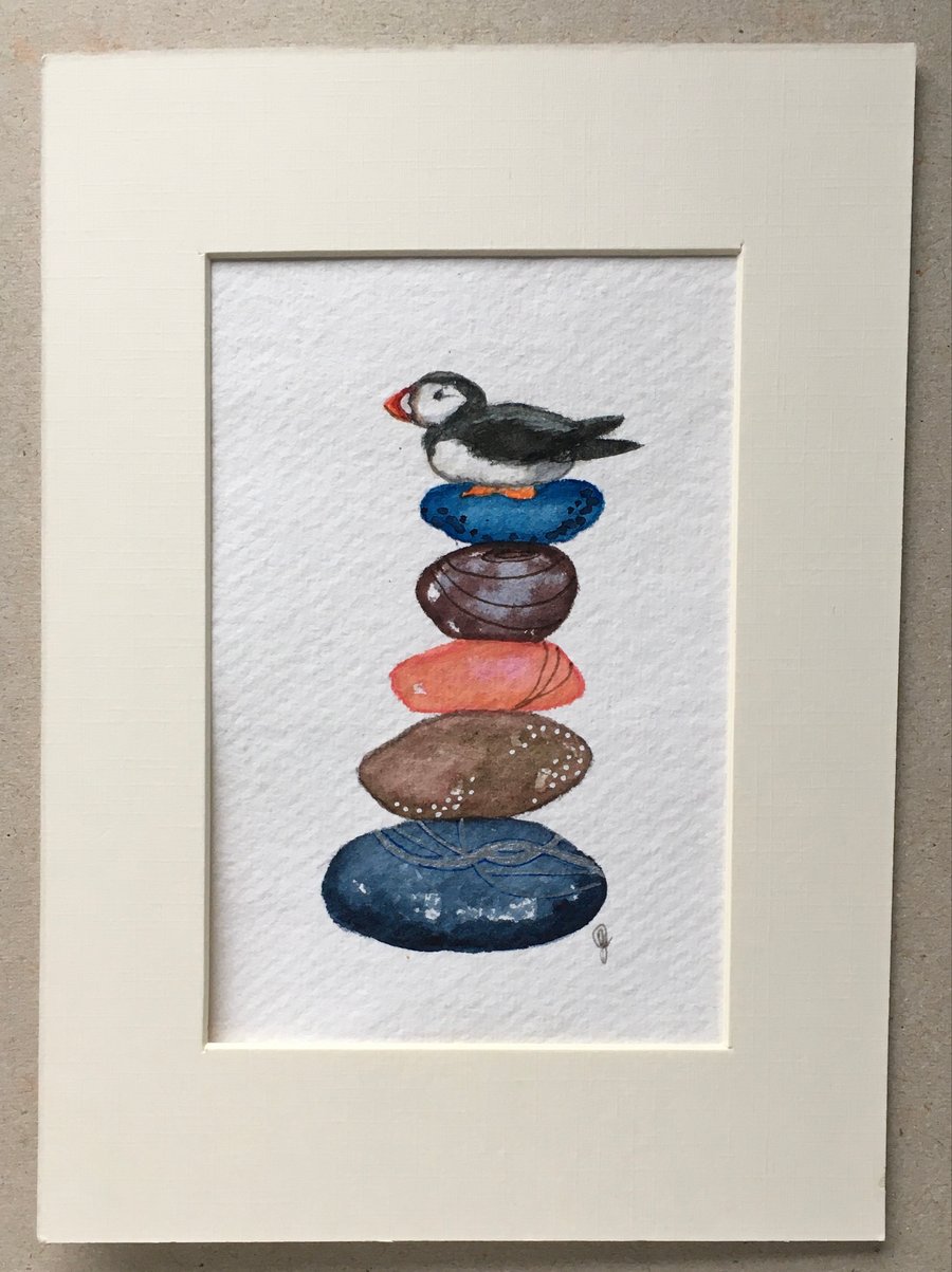 Pebble pile with puffin painting 