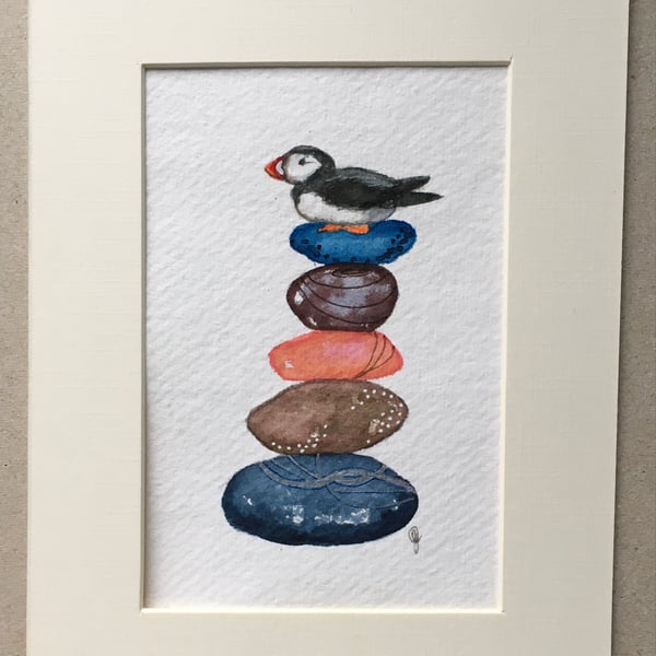 Pebble pile with puffin painting 