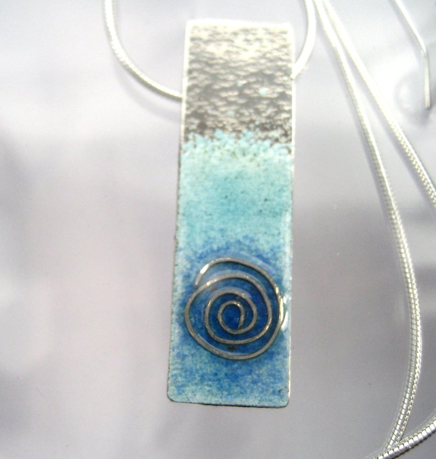 Enamelled sterling silver necklace with sea swirl.