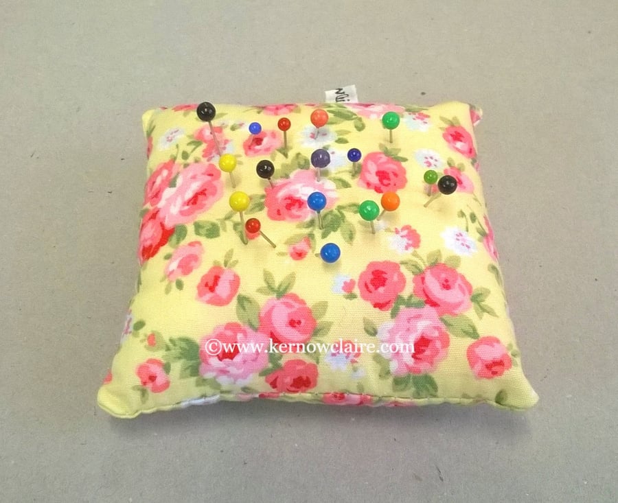 Small pin cushion in yellow with pink flowers