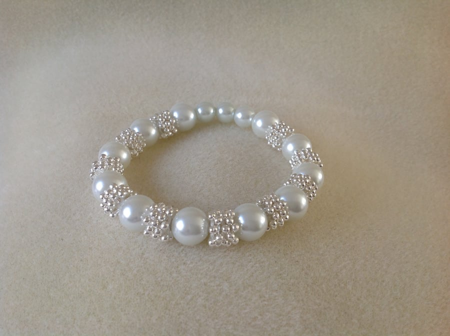 White pearl and silver snowflake bracelet.