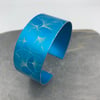 Turquoise ginkgo aluminium cuff.