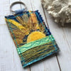 Up cycled embroidered sun keyring or bag charm. 