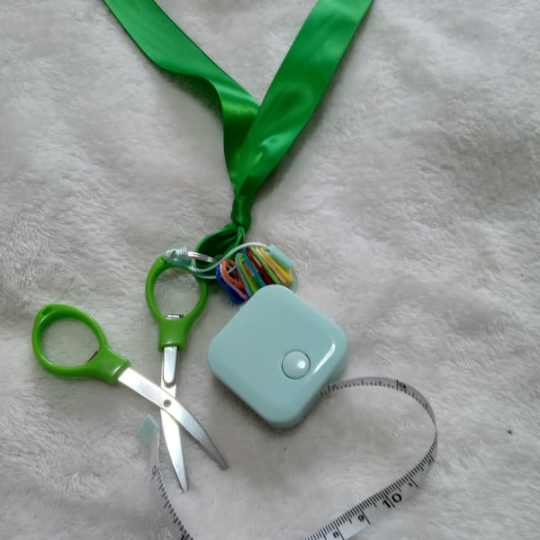 green satin ribbon with crochet and knitting accessories