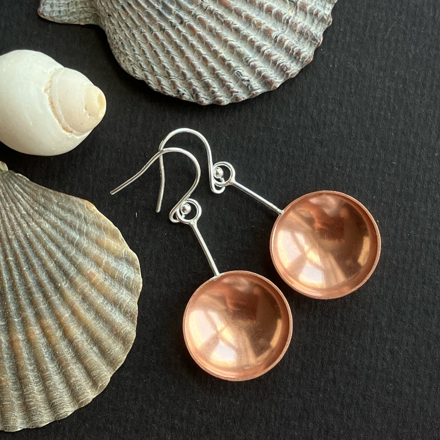 Sterling silver and copper spoon dangle earrings with hammered detail.