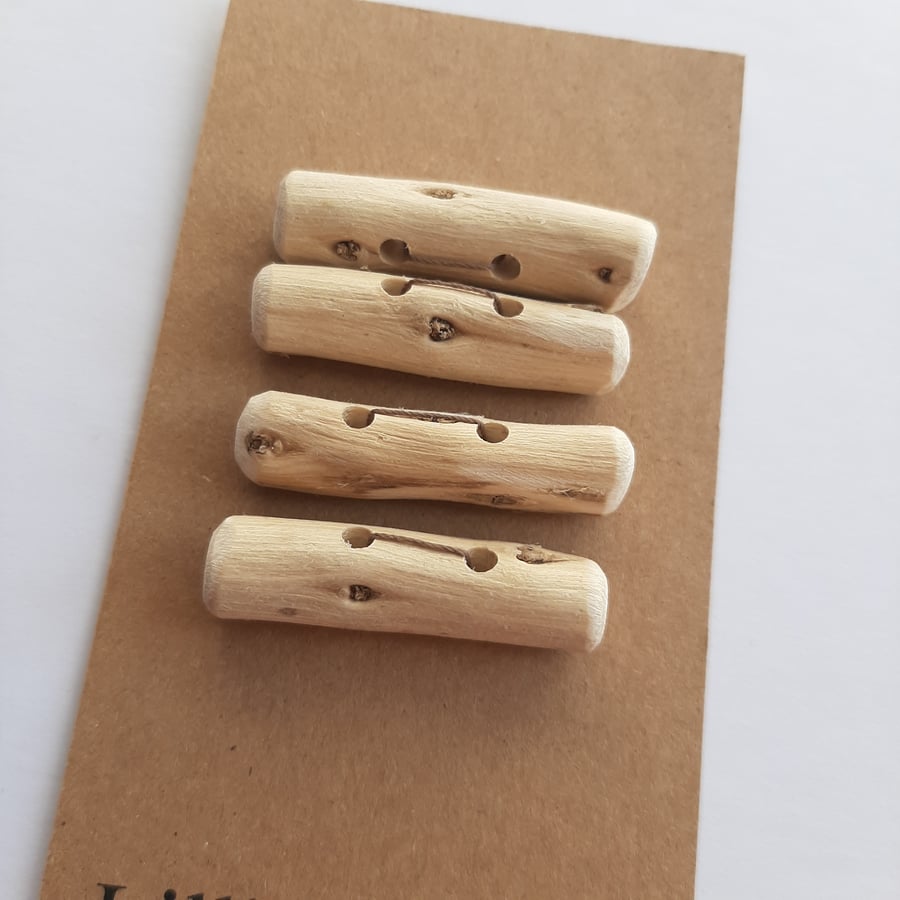 Four small driftwood toggle buttons