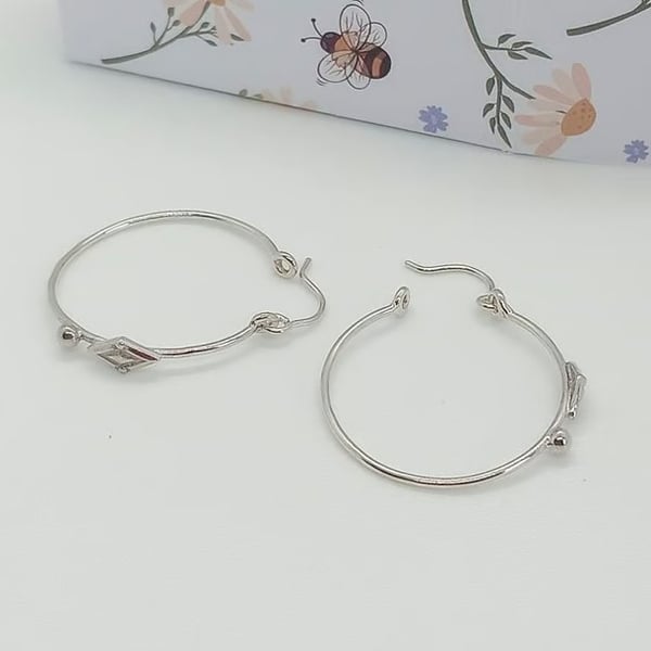 Sterling silver hoop earrings diamond bead design detailing 