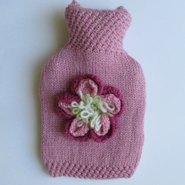 Hand knitted pink peony hot water bottle cover