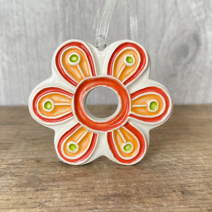 Intricate ceramic flower decoration orange