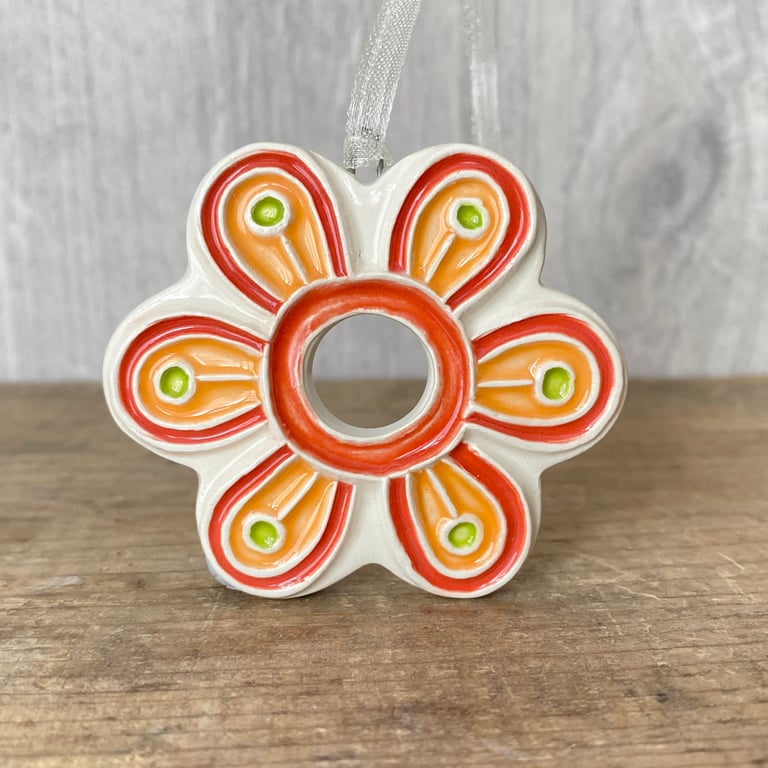 Intricate ceramic flower decoration orange